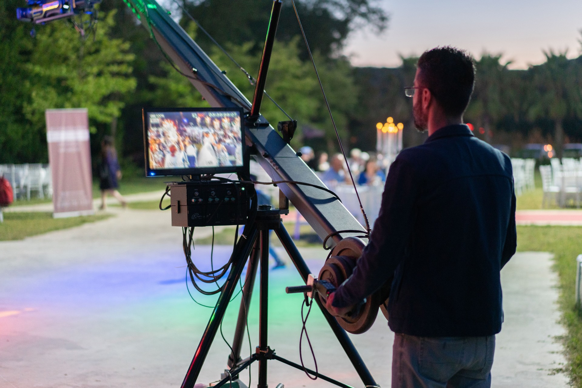 A camera man operating a camera jib during the wedding.